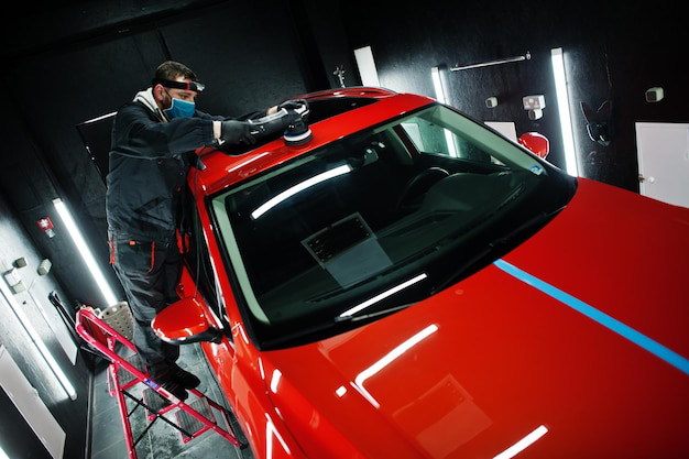 A car detailer polishing a car
