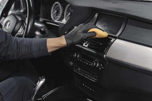 A person cleaning a car's interior