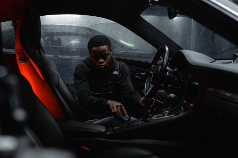 A man cleaning the interior of a car