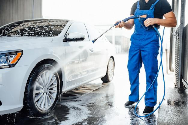 A person washing their car